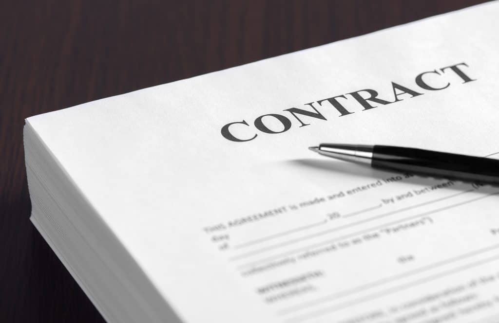 white contract with a pen