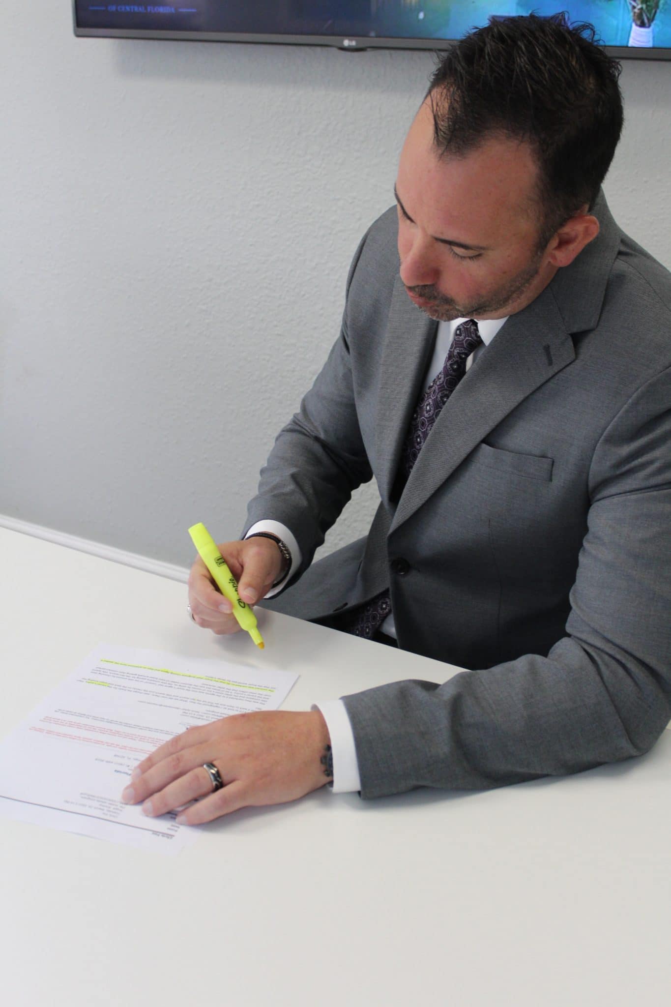 Man with highlighter helping with closing paperwork