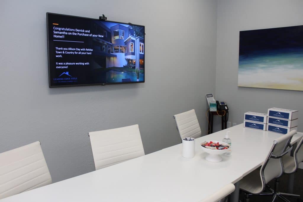 Office room with a TV displaying a congratulations message