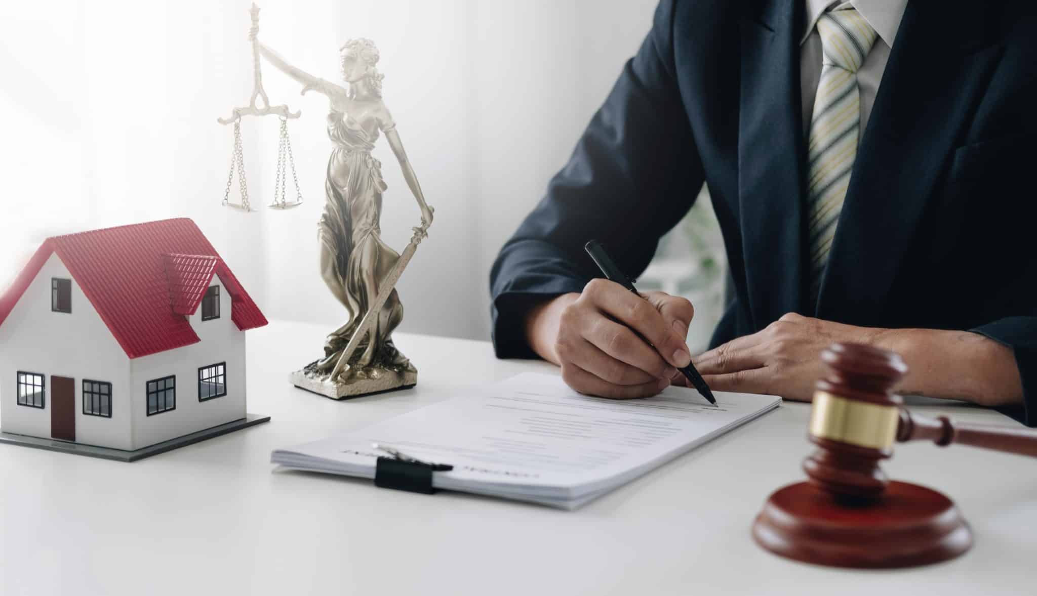 A lawyer filling out legal paperwork for a real estate transaction