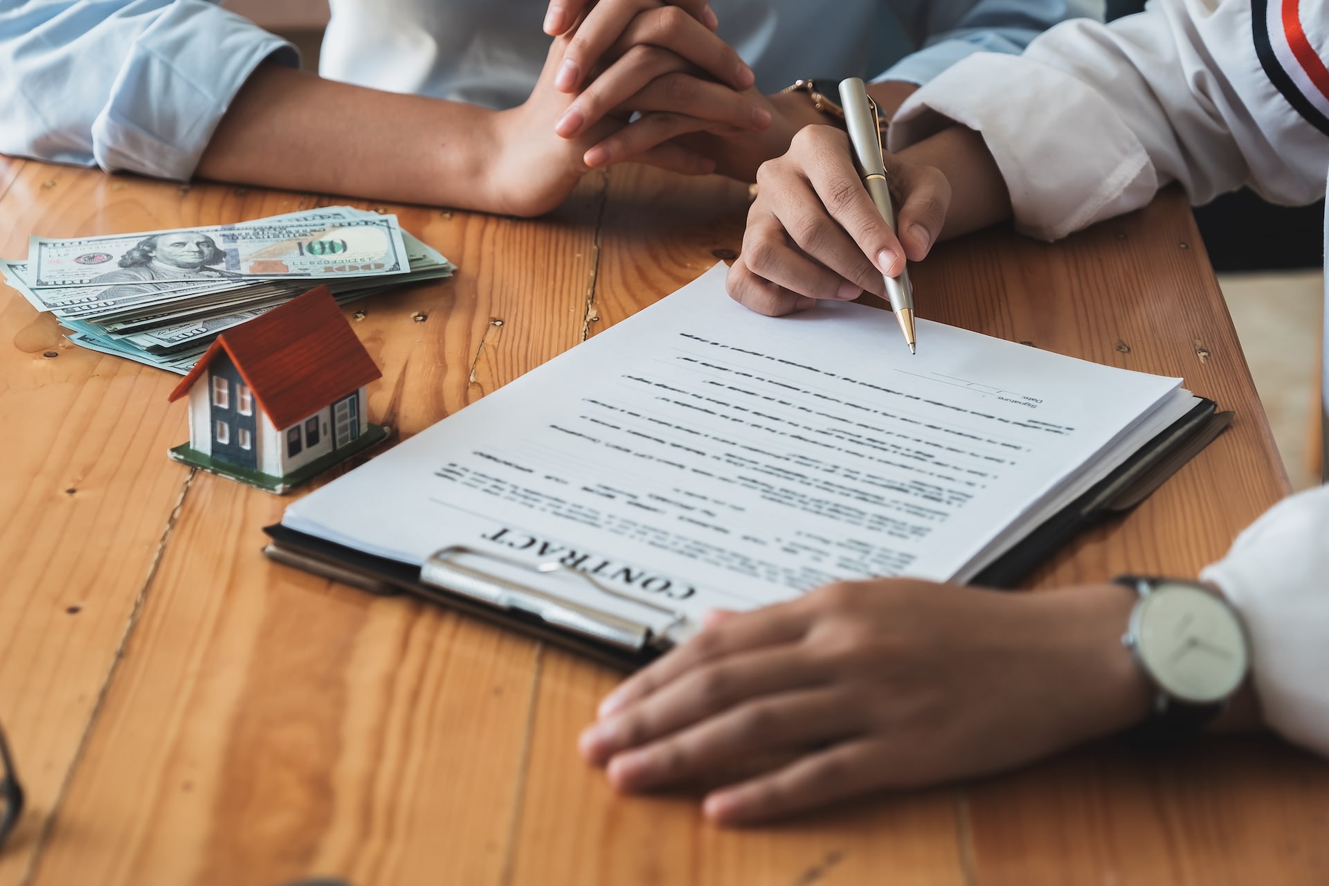A real estate agent reviewing a contract with a potential home buyer