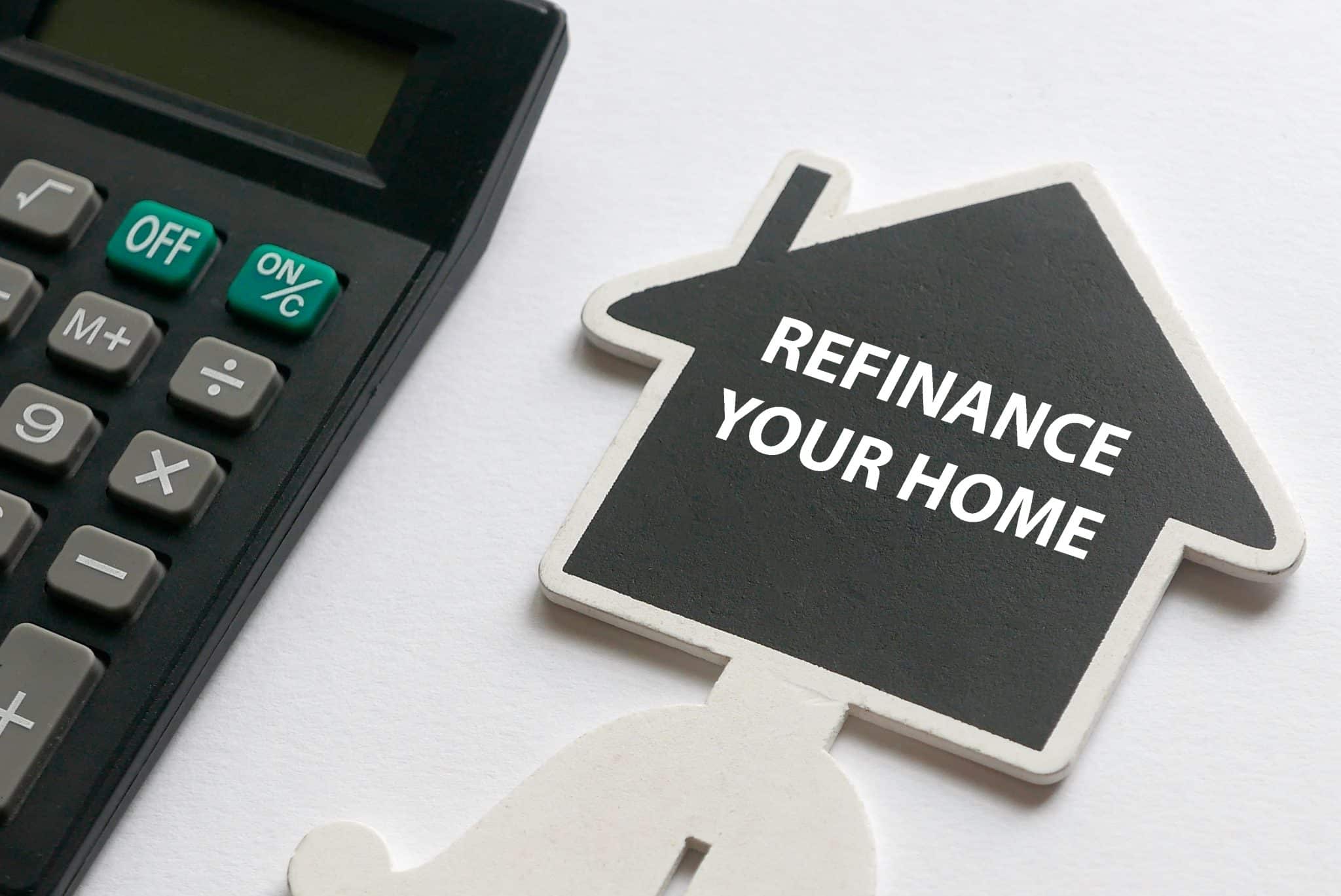 A "refinance your home" sign next to a calculator.