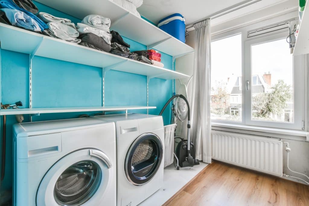 Interior of small clean laundry room in modern house